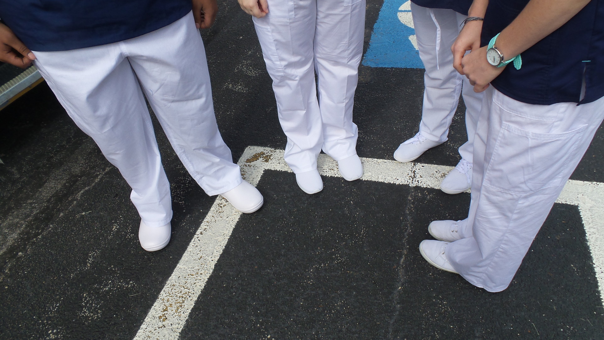 Students display white uniform shoes