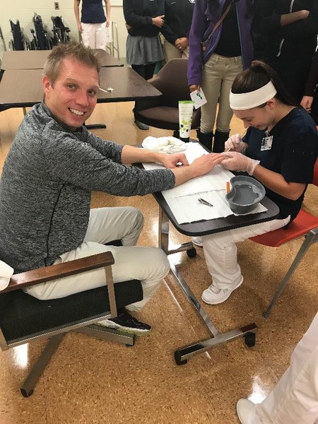 Stephen Sarsany, Beecher HS Counselor allows KACC Student to trim his nails.