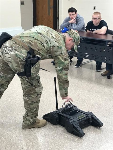 Officer Cox demonstrates tactical robot.