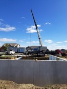 Installation process of precast and pre-studded walls for basement.