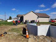 Installation process of precast and pre-studded walls for basement.