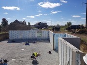 Installation process of precast and pre-studded walls for basement.