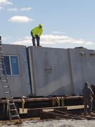 Installation process of precast and pre-studded walls for basement.