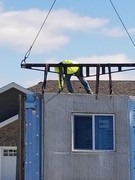 Installation process of precast and pre-studded walls for basement.