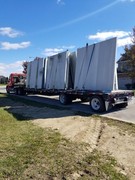 Installation process of precast and pre-studded walls for basement.