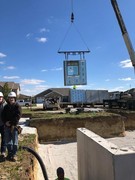 Installation process of precast and pre-studded walls for basement.