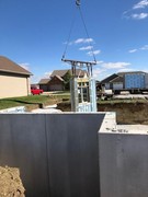 Installation process of precast and pre-studded walls for basement.