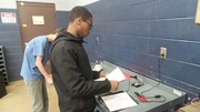 Section 2 Students undergoing basic automotive electrical theory testing.