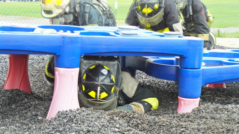 Fire-Rescue-EMR students undergoing SCBA training on the preschool lab playground.