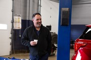 Jason Gomez Holding a Cup of coffee and talking.