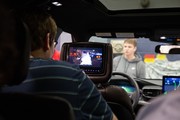 Student looking at back seat television