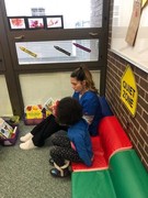 KACC Student reading to a Pre-K Student