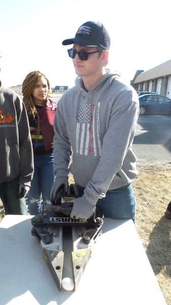 Picture of KACC Student utilizing Jaws of Life to pick up an Egg