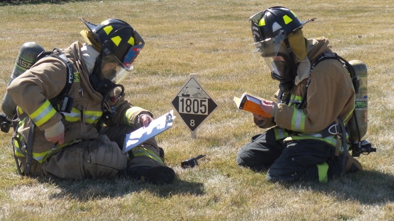 Two Fire-Rescue-EMR Students utilizing DOT-EGR Manual For Hazmat Training Exercises.
