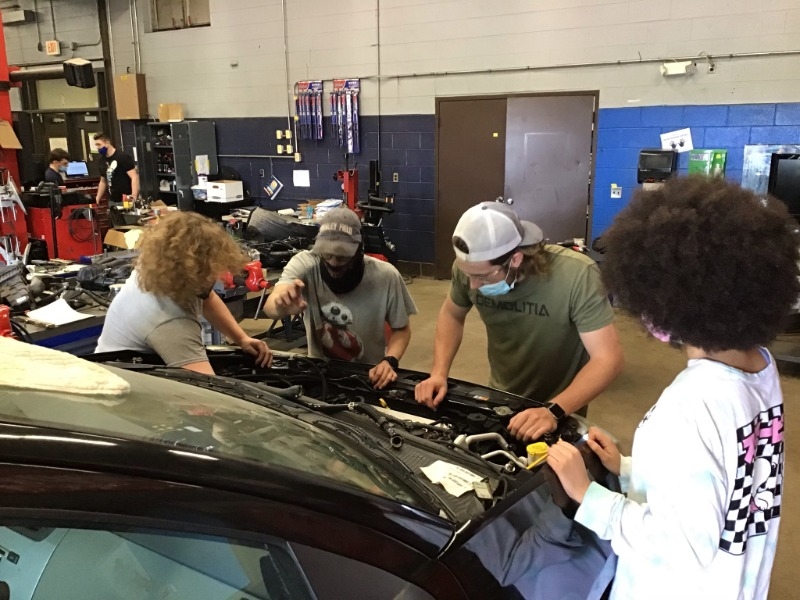 Students working on replacing engine