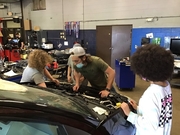 Students working on replacing engine