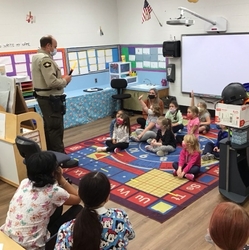 Deputy Powell speaking to Preschoolers about his police equipment.